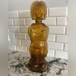vintage amber glass decanter shaped like an "Old West Indian" figure.